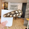 Elegante fermaglio a goccia dorato con strass scuri scintillanti e gemme trasparenti - Goccia d'acqua Caffè