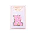 Macro shot of pink chenille letter R patch with gold glitter edge and peel-and-stick backing - Letter R