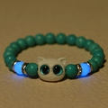 Luminous cat head bead bracelet featuring glowing blue tiger eye stones in dark lighting - Turquoise (Cyan)