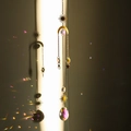 Gold crystal suncatcher with moon and star metal accents creating rainbow light reflections - Design No.17