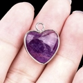 Polished purple amethyst heart pendant with a sleek silver metal bezel rim - Amethyst Silver Edging