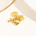 Detailed view of gold travel pendants featuring airplane, heart, and luggage on beige - Travel World - Blue Heart (ZYN-DME895G-1)