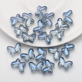 Macro detail of 10x14mm gray-blue butterfly glass beads for DIY jewelry making - Dark Blue Plated