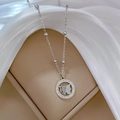 Detail van zilveren vlinderhanger met glittereffect en diamanten op zijde - Titaniumstaal / Zilver