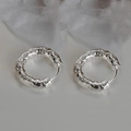 Detailed view of silver hoop earrings with unique lava texture and clasp closure - Lava Texture Hoop / Silver