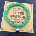 Green stone bead bracelet with silver heart charm on reminder card for friendship - Green With Card