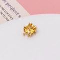 Macro shot of square yellow zircon pendant with gold four-prong setting for DIY jewelry - Yellow