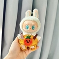 Plush doll outfit featuring green rabbit ear hat and yellow corduroy overalls with orange - Two-piece Set Of Woolen Pumpkin Overalls / First And Second Generation Keychains Are Compatible With La Cloth Dolls. Dolls Not Included.
