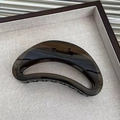 Detailed view of large amber tortoiseshell hair claw clip with strong metal spring - Black