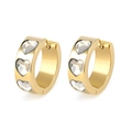 Detailed macro view of 18k gold heart-shaped huggie earrings with clear cubic zirconia - White