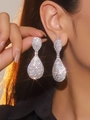 Elegant silver teardrop earrings with shimmering rhinestones worn by a model - Silver Gorgeous Pavé Style (DTE1316611S-W)