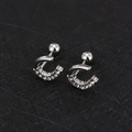 Macro view of C-shaped silver screw-back cartilage stud with sparkling cubic zirconia - U Shape - Steel