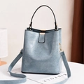 Light blue faux crocodile skin bucket bag with gold metal buckle and adjustable strap - Blue Stone Pattern
