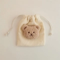 Detailed view of cream corduroy drawstring pouch with a cute brown plush bear motif - Off-white (Milk Tea Bear)