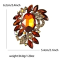 Vintage bronze alloy brooch with amber glass rhinestones and dimensions shown on white background - Brown