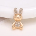 Detailed view of a golden metal rabbit brooch adorned with shimmering rhinestones - Gold Rabbit