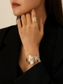 Golden flower texture ring and bracelet set worn by a model in elegant pose - Gold Bangle + Ring Set
