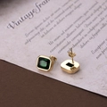 Elegant gold titanium earrings with rectangular green zircon on vintage paper background - Green Gold