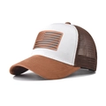 Detail of the USA flag leather patch on the suede brim of a vintage trucker hat - Khaki and White