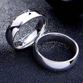 Macro shot of a pair of high polished 6mm stainless steel plain band rings - US 5 / 6mm / Silver