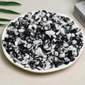 Polished black and white zebra jasper tumbled stones displayed on a white plate - Black And White Zebra (7-9mm) 100g