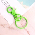 Green painted metal lobster clasp keychain with round ring on marble background - Grass Green