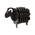 Detail of interlocking dark brown wooden sheep coasters and decorative home ornament - Black