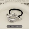 Minimalist elastic hair tie featuring a silver textured metal wrap decoration, size 6.4x4cm - Knotted Design Silver