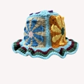 Handmade crochet bucket hat featuring colorful floral patterns and a wavy knit brim - One Size / Kite Hat Blue