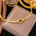 Flat gold snake chain necklace with hollow heart pendant on a premium jewelry box - Hollow Heart Necklace / Gold