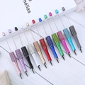 Detailed view of colorful rhinestone-studded metal ballpoint pens in various vibrant colors - 1.0mm Bullet Tip / Random Mixed Colors