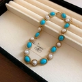 Close-up of vintage gold necklace with turquoise stones and pearls in a velvet jewelry box - Necklace / Blue Necklace