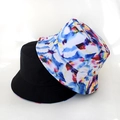 Detail of reversible bucket hat showing solid black and colorful oil painting print - Colorful Marble Tie Dye