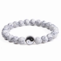 Detailed macro view of white turquoise beads with a silver Yin Yang Tai Chi charm bracelet - White Turquoise (Tai Chi Pendant)