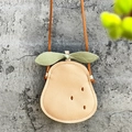Close-up of pear-shaped kids crossbody bag with lychee texture and green leaf detail - Beige Pear