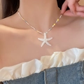 Close-up of a colorful beaded necklace with a white starfish pendant on a model's neck - 3# Necklace (White)