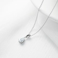 Elegante collar con colgante de gota de plata en cadena fina sobre fondo de seda blanca - Platinado Con Zirconia Blanca