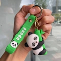 Detailed close-up of a 3D panda holding bamboo with a green silicone strap and metal ring - Bamboo Strap - Holding Bamboo Right