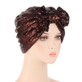 Detail of a dark brown sequin turban cap with a stylish 3D bow design on a mannequin - Coffee
