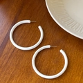Minimalist white enamel twisted hoop earrings on a warm wooden surface for women - White Ring