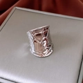 Macro view of wide silver ring with irregular geometric texture on jewelry case - Irregular Geometric Texture (Silver) / Silver