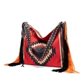 Detailed view of woven Bohemian tote bag featuring ethnic patterns and long black orange tassels - Style 10