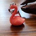 Close-up of pink flamingo keychain with detailed feather texture and silver metal clasp - Relaxed Flamingo