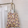Detailed view of dark purple floral canvas tote bag hanging in a home setting - Purple Gray Yellow Floral