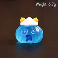 Blue translucent resin monster figurine with white cap and small yellow horns, 2.1cm wide - Blue Bandage Monster