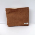 Detail of a brown corduroy makeup bag with a zipper and a small white brand label - Brown