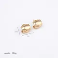 Detailed view of irregular polished gold hoop earrings with 1.5cm height and 1.6cm width - Gold Minimalist Curved Ear Buckle