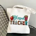 Blessed Teacher white canvas tote bag with leopard print graphics on a black chair - Style C2