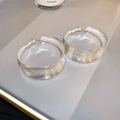 Macro detail of large silver-tone C-shape hoop earrings with a brushed metal texture finish - Silver (925 Sterling Silver Earring Post)