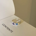 Silver open ring featuring purple heart, blue square and green round gemstones on a book - JZ0053 (Heart & Square Gems)
